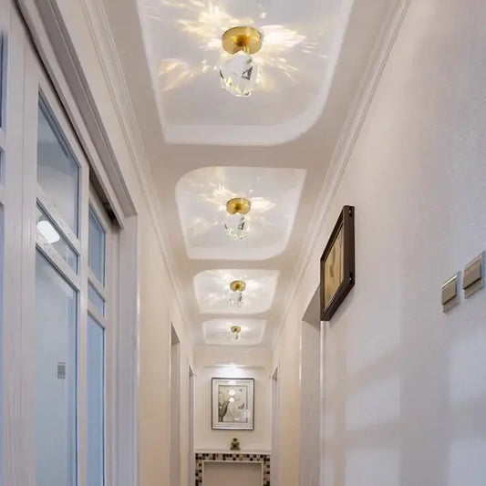 Elegant gold ceiling light fixture with clear crystal pendants designed for hallway entrance lighting