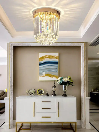 Elegant crystal ceiling light with gold frame and clear glass prisms illuminating hallway decorbites elegant crystal design