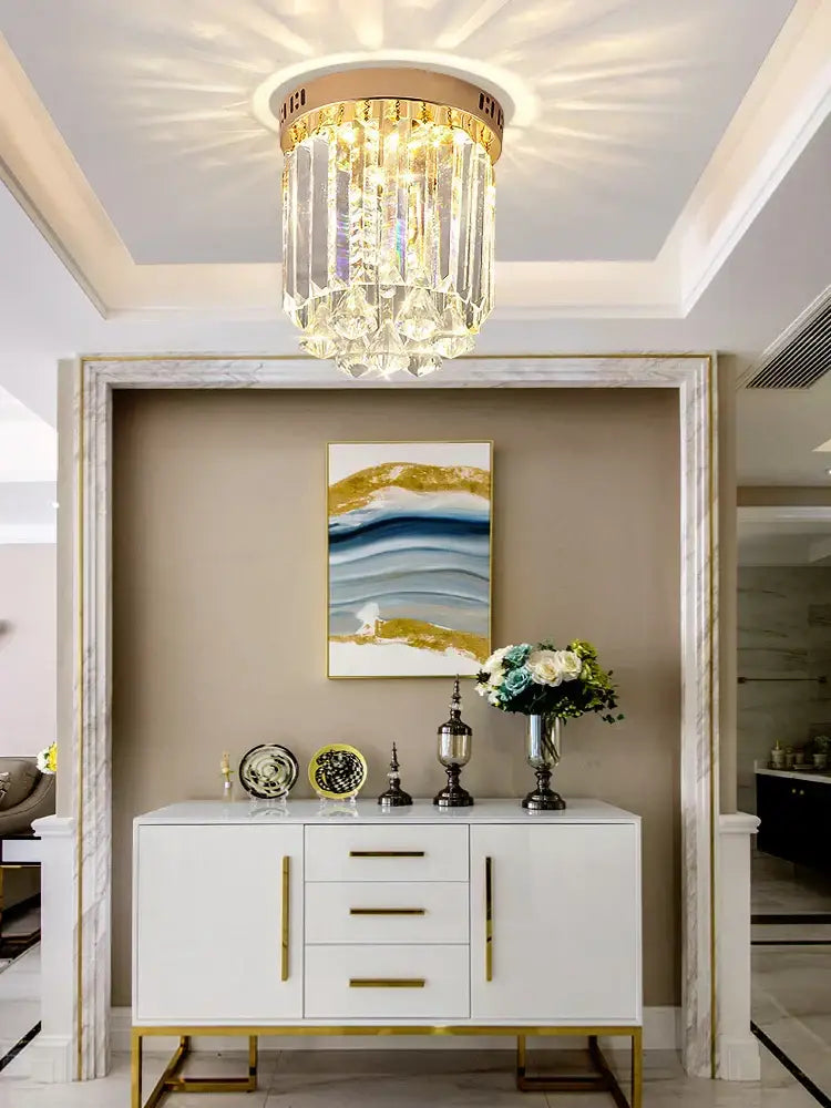 Elegant crystal ceiling light with gold frame and clear glass prisms illuminating hallway decorbites elegant crystal design