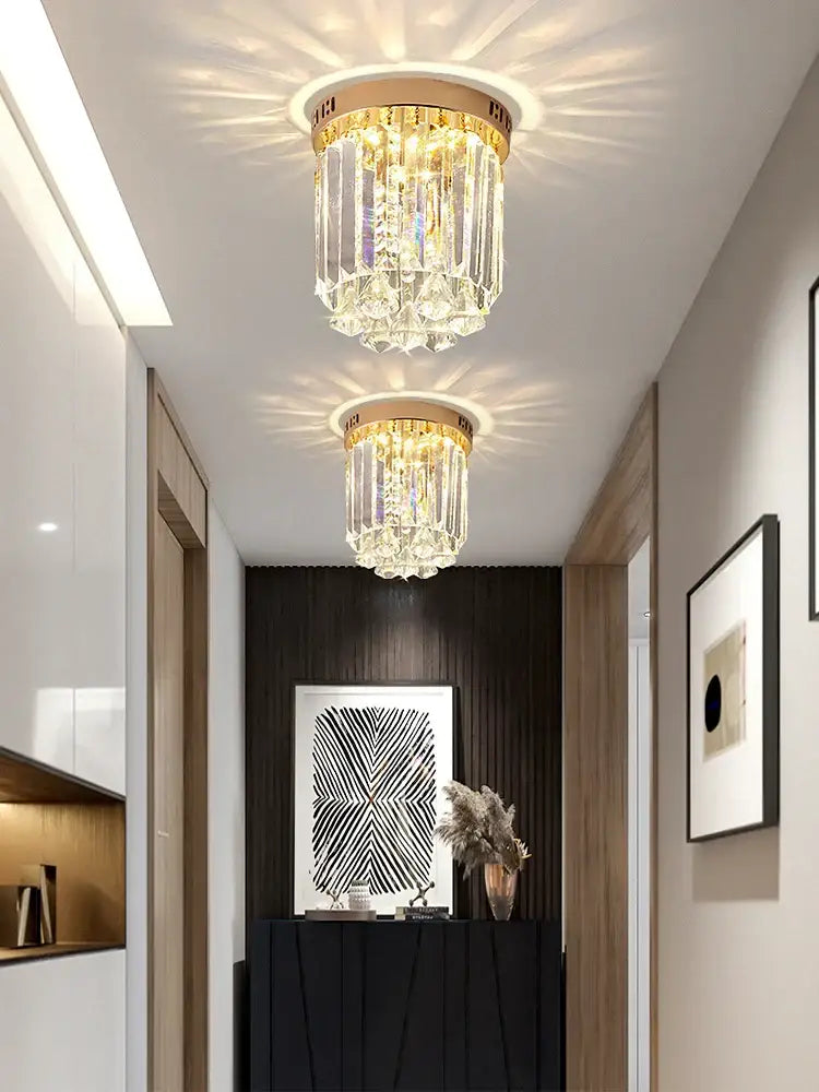 Elegant gold crystal ceiling light with cascading clear glass prisms and circular brass base for hallway decorbites elegant crystal