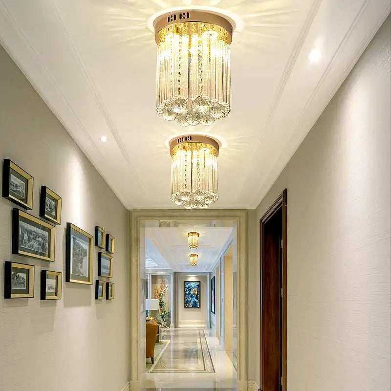 Elegant gold crystal ceiling light with vertical glass prisms and circular brass base for decorbites elegant crystal hallway decor