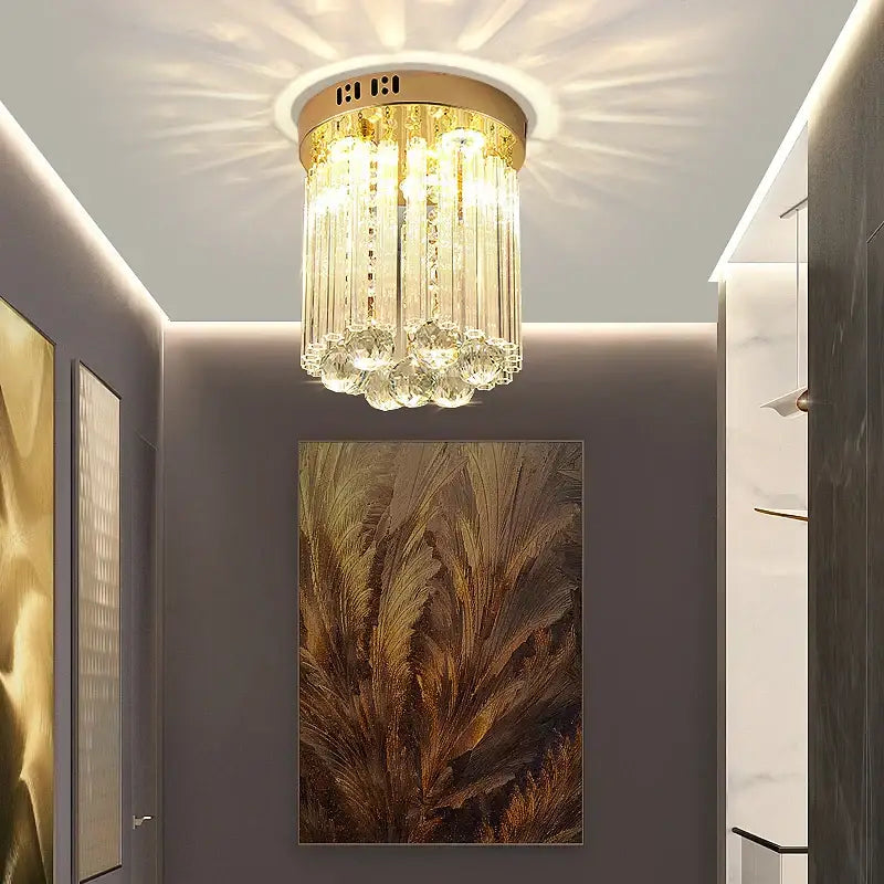 Elegant gold crystal ceiling light with cascading glass prisms and circular base for hallway decorbites elegant crystal