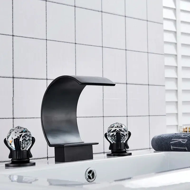 Black matte-finish waterfall basin faucet set with crystal globe handles providing elegant bathroom tap design