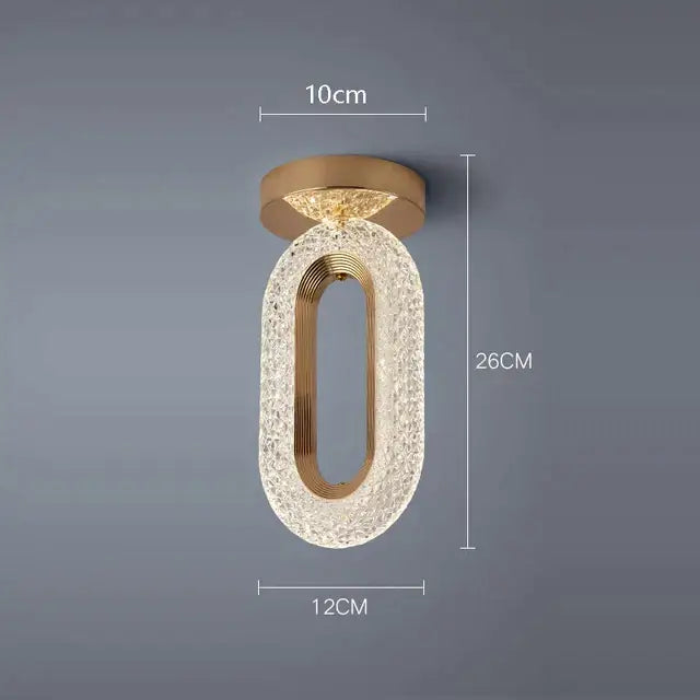 Elegant gold crystal oval pendant light chandelier with textured body and central metallic frame for living room