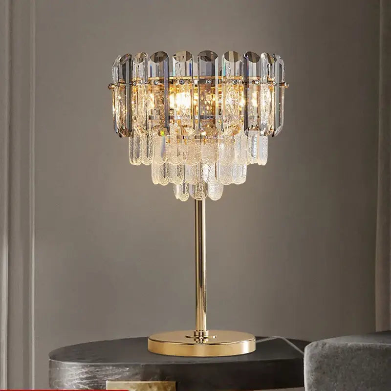 Elegant gold crystal table decor lamp with cascading clear and frosted prisms for bedroom desk lighting