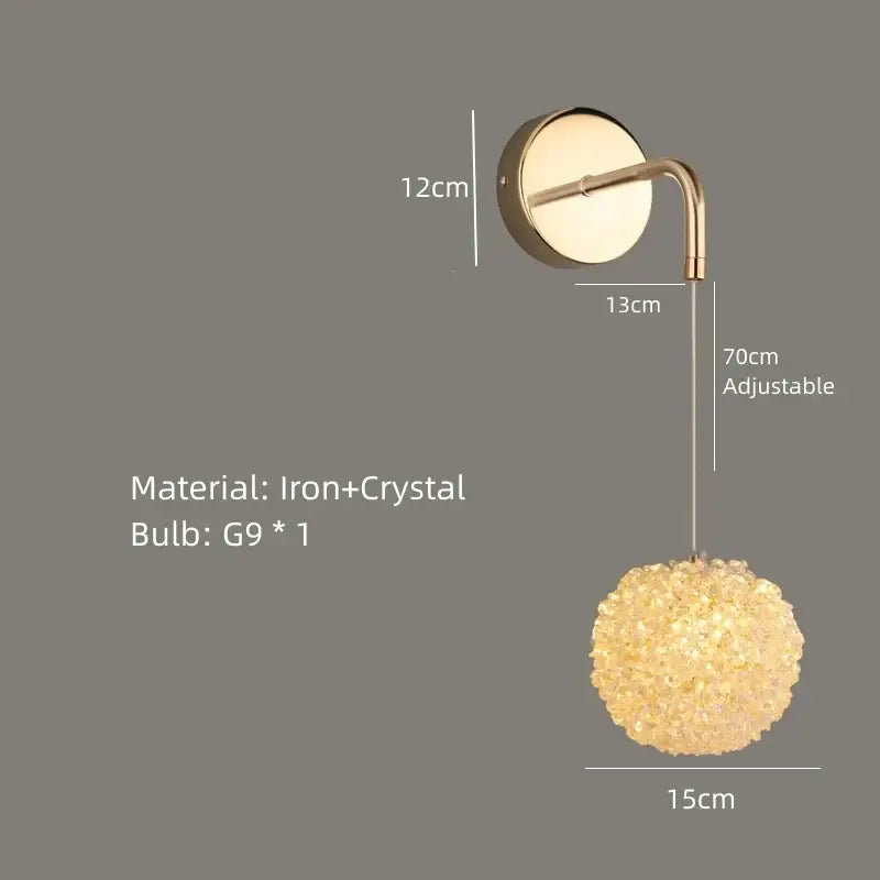 Elegant gold crystal wall lamp with a curved iron arm and glowing spherical crystal pendant for bedroom decorbites lighting
