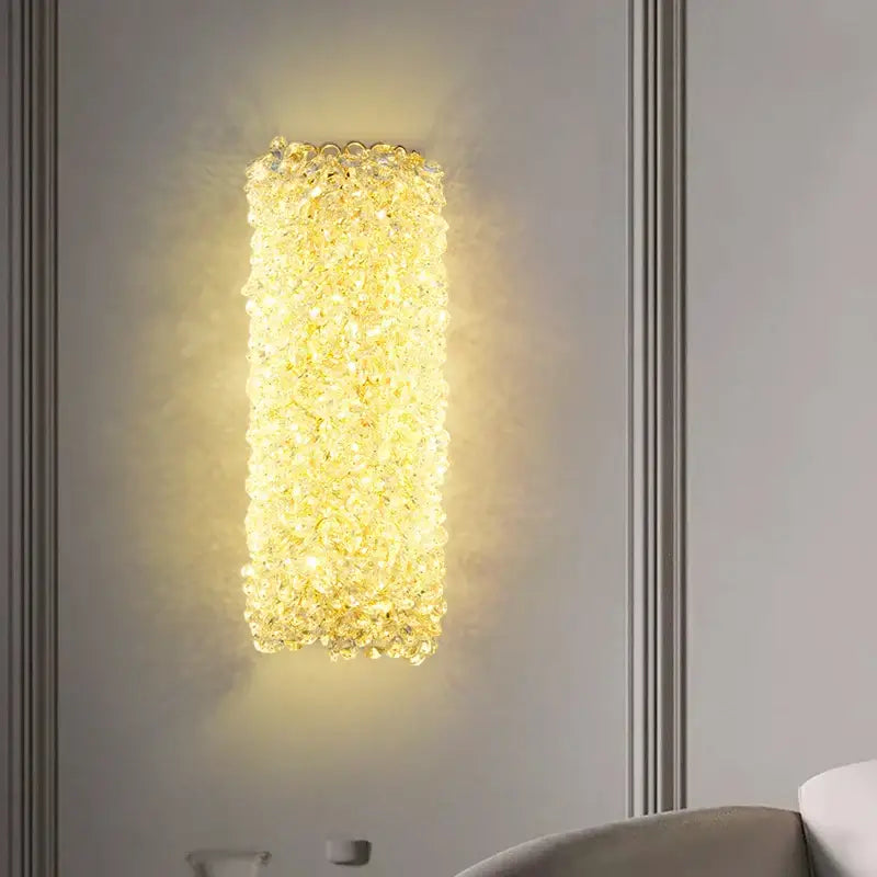 Elegant gold crystal wall lamp featuring clear faceted beads emitting warm glow for bedroom sconce lighting decorbites wall lamp