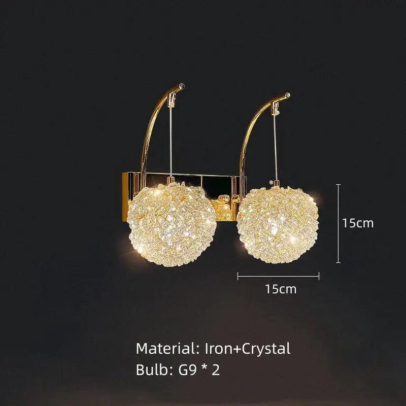 Elegant gold crystal wall lamp featuring two spherical crystal clusters suspended by curved iron arms for bedroom decorbites lighting
