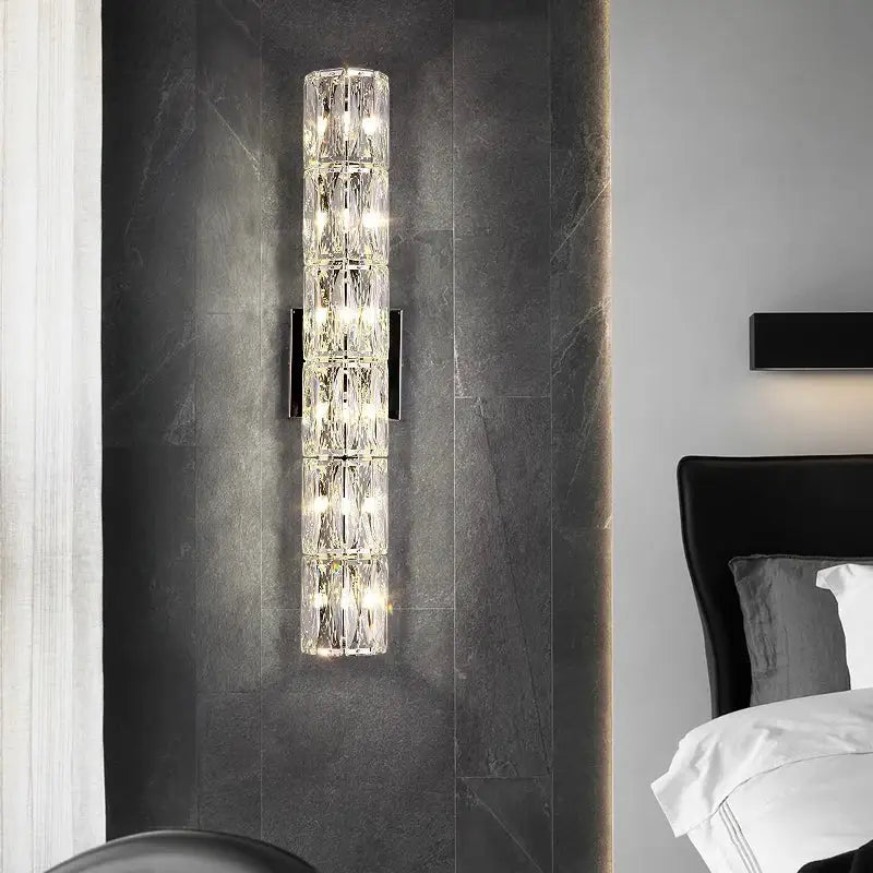 Elegant gold decorbites crystal wall lamp featuring stacked clear crystal segments with embedded lights for living room decor