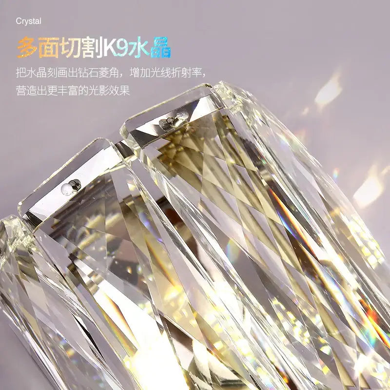Elegant gold crystal wall lamp featuring a faceted k9 crystal pendant refracting vibrant rainbow hues decorbites crystal wall