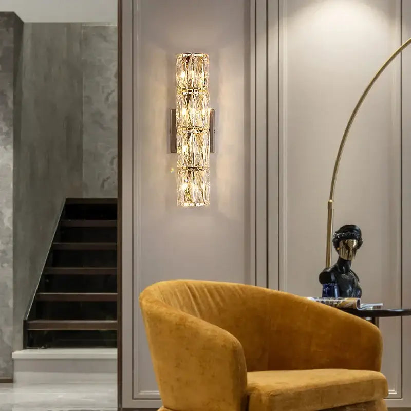 Elegant gold crystal wall lamp with faceted stacked crystals and metal accents ideal as decorbites crystal wall sconce