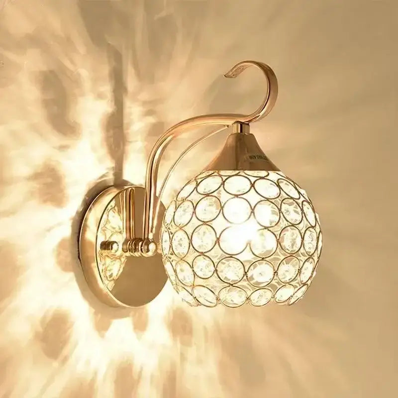 Elegant gold crystal wall sconce with spherical glass shade and circular crystal embellishments for bedroom decorbites crystal wall