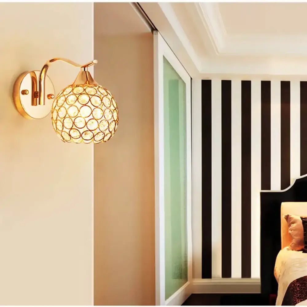 Elegant gold crystal wall sconce featuring a spherical globe design perfect for bedroom decorbites crystal wall lighting