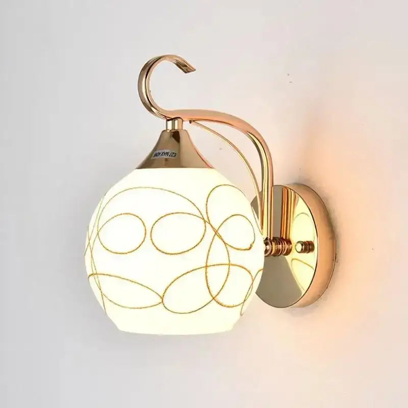 Elegant gold crystal wall sconce with a spherical frosted glass shade and brass-finished arm for bedroom decorbites crystal wall lighting