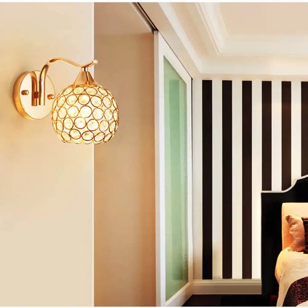 Elegant gold crystal wall sconce featuring a spherical globe design for bedroom lighting by decorbites crystal wall