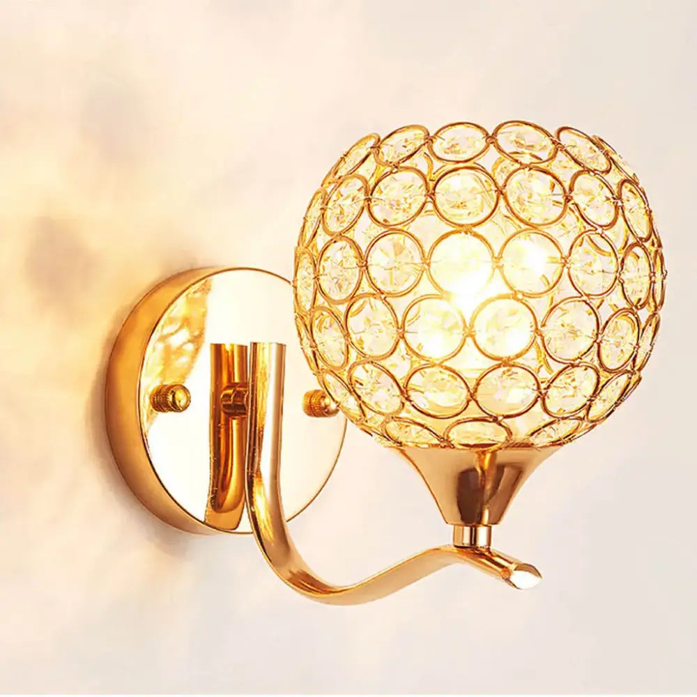 Elegant gold crystal wall sconce featuring a spherical globe design by decorbites crystal wall for bedroom lighting