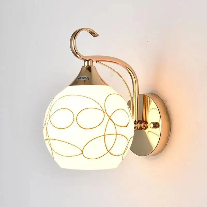 Elegant gold decorbites crystal wall sconce with frosted glass globe and delicate gold oval patterns for bedroom lighting