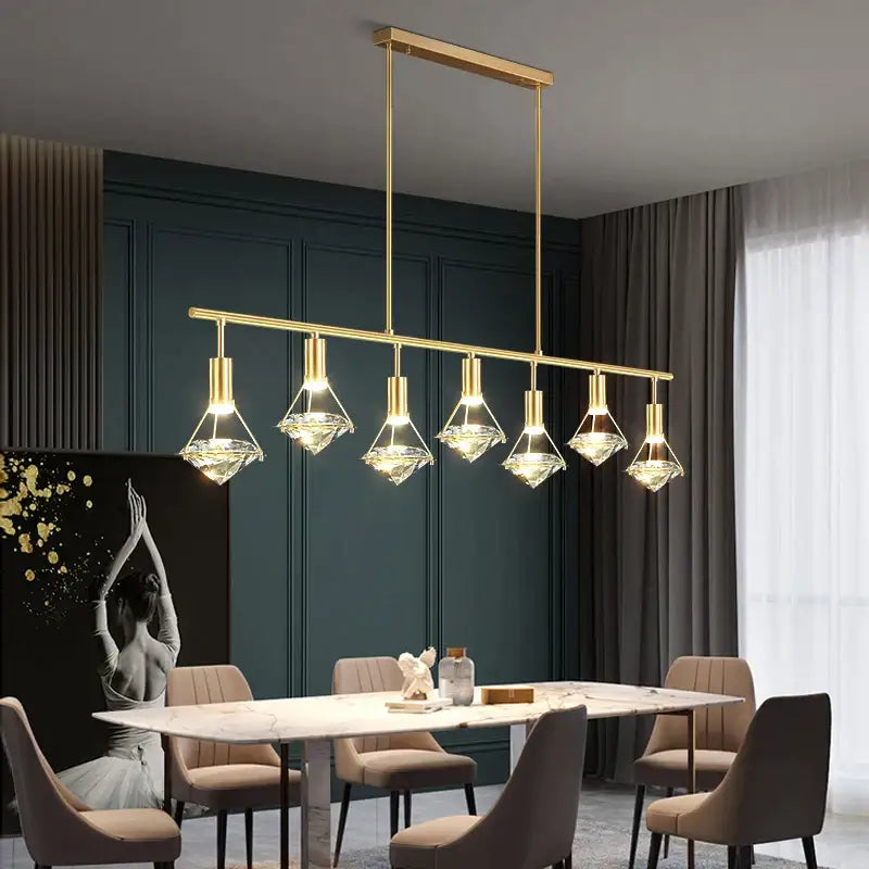 Elegant gold diamond crystal pendant light featuring six glass diamond-shaped pendants on a modern bar for dining room