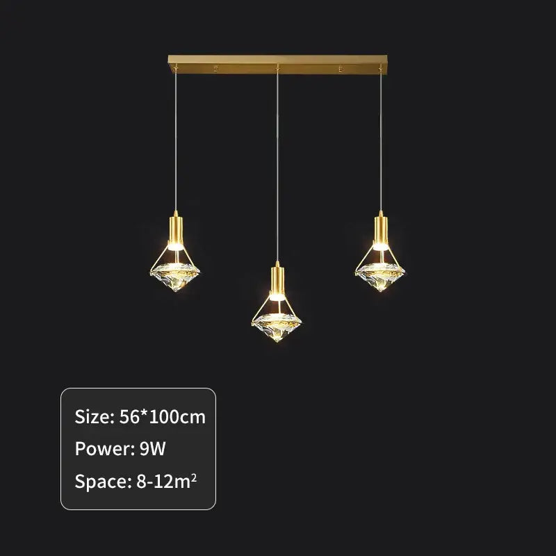 Elegant gold diamond crystal pendant light with clear crystal accents hanging from a rectangular bar for dining room