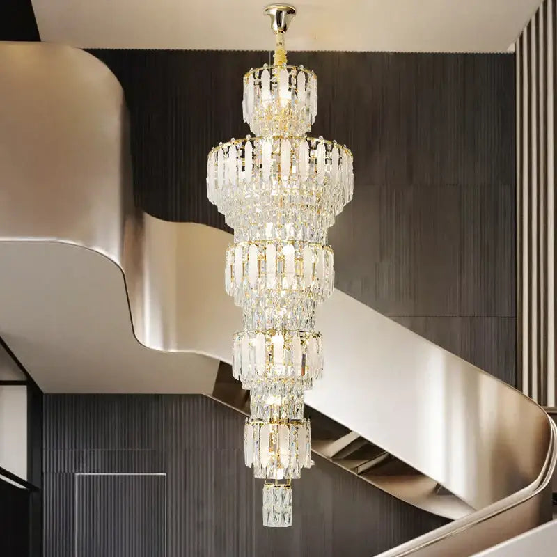 A multi-tiered crystal duplex villa light chandelier with gold-toned metal accents for spiral staircase lighting