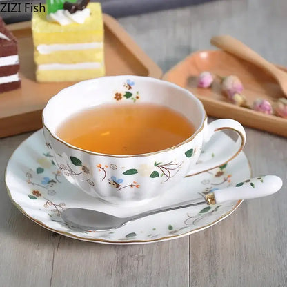 Elegant gold flower porcelain cup and saucer set with gold-trimmed rim filled with amber tea for decorbites elegant gold decor