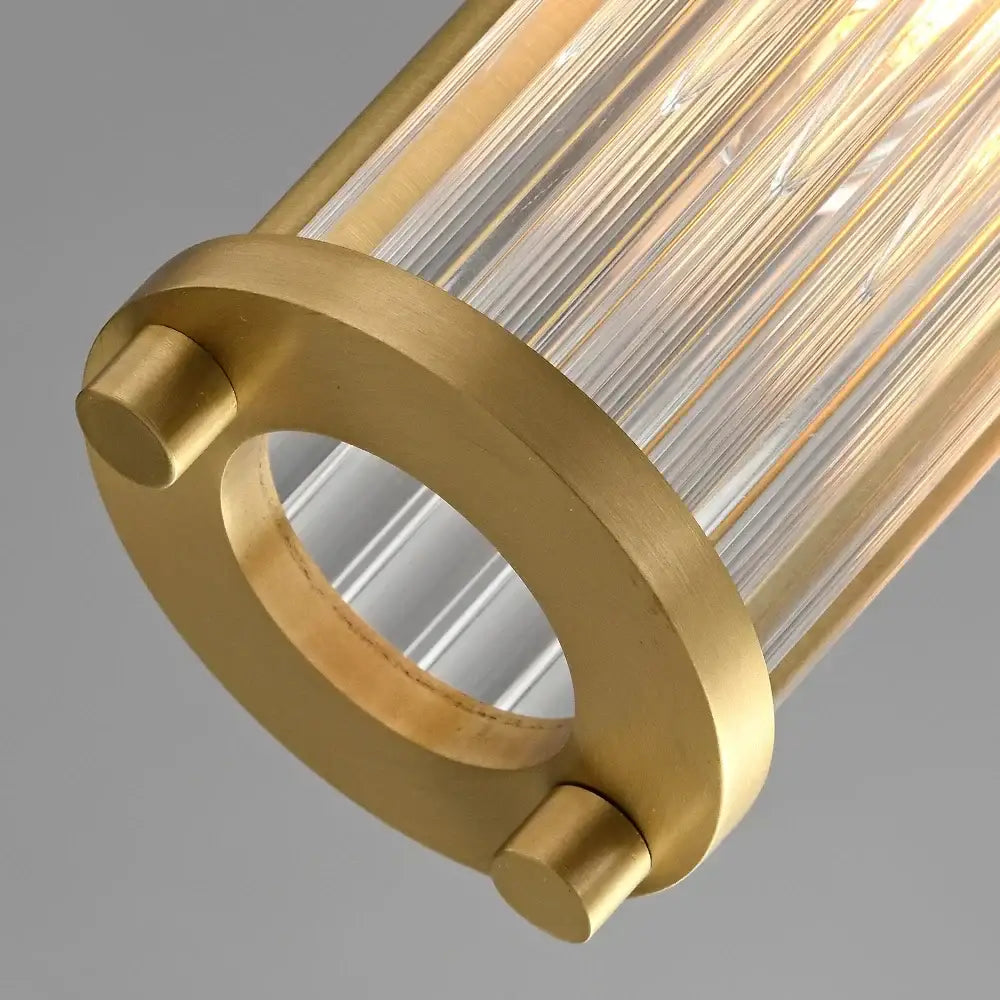 Elegant gold glass shade pendant lights with cylindrical pendant lights featuring clear ribbed glass rods and brushed brass fixture