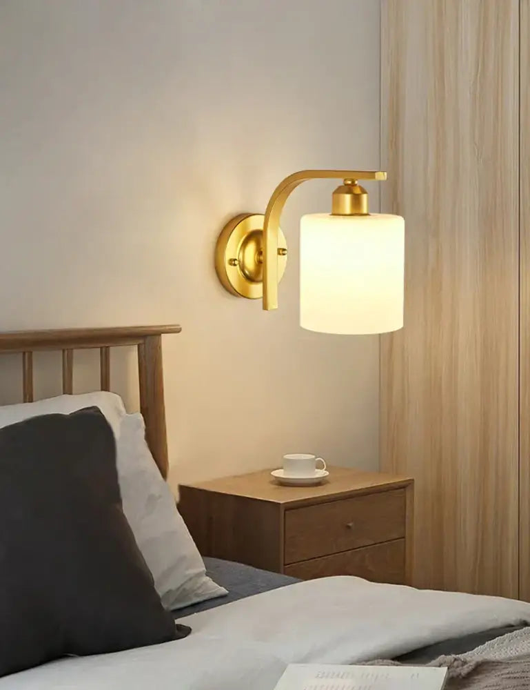 Elegant gold iron wall lamp with frosted glass shade featuring a gold toned decorbites iron wall lamp for bedroom decor