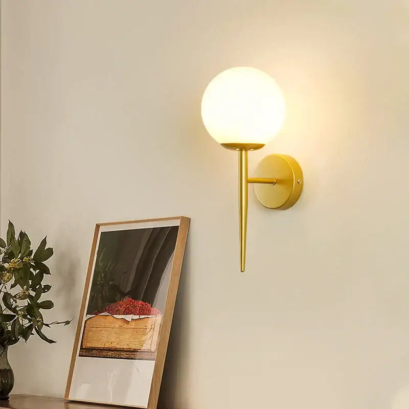 Elegant gold iron wall lamp with spherical frosted glass globe for bedroom decorbites iron wall lamp design