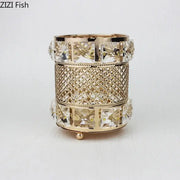 Elegant gold lattice hollow glass jar candle holder with intricate design and clear crystal accents for makeup brushes