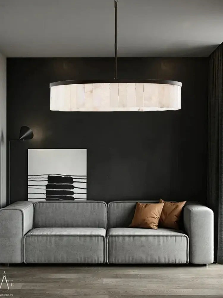 Modern oval pendant light with sleek black frame and white fabric shade paired with decorbites gold marble ceiling fixture