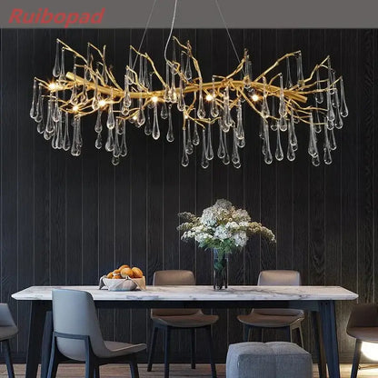 Elegant gold metal branch chandelier with glass water drop crystals and dangling teardrop pendants for dining room lighting