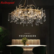Elegant gold metal branch chandelier with glass water drop crystals and dangling teardrop pendants for dining room light