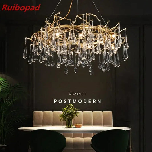 Elegant gold metal branch chandelier with glass water drop crystals and dangling teardrop pendants for dining room light