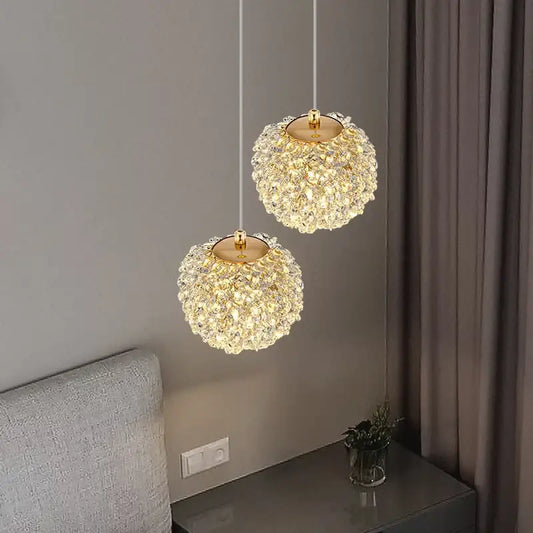 Two elegant gold metal crystal pendant lights with spherical clear faceted crystals for dining room decorbites gold metal