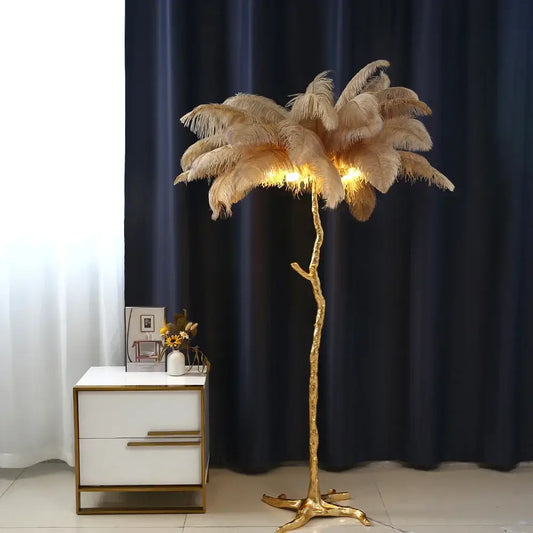 Elegant gold ostrich feather floor lamp with a tree-like base and glowing lights by decorbites elegant ostrich