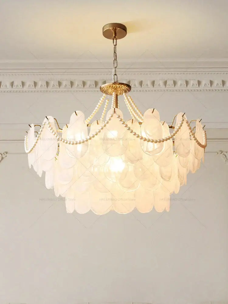 Delicate layered chandelier garden light with translucent white glass shells and gold-toned metal for dining room