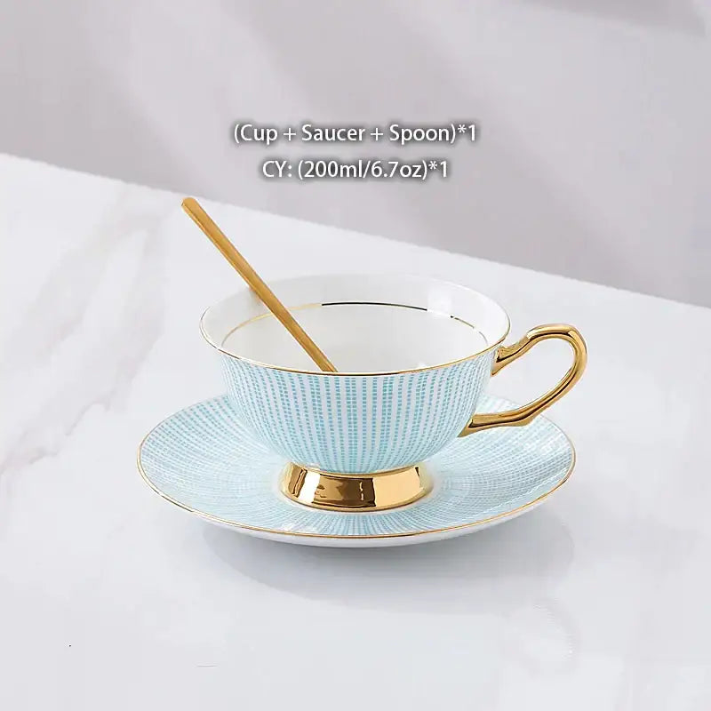 Light blue ceramic teacup with gold porcelain trim and matching saucer in decorbites gold porcelain tea set with bird figurine