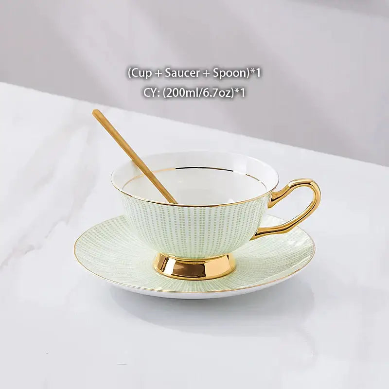 A delicate mint green decorbites gold porcelain tea cup with gold trim and textured pattern on matching saucer