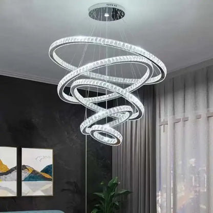 A modern decorbites elegant gold rings chandelier with multiple glowing crystal spiral rings for dining room decor