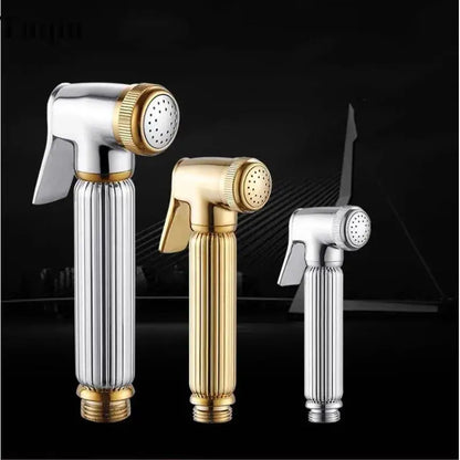 Three elegant handheld bidet sprayers in gold and silver metallic finishes for bathroom use in an elegant kit