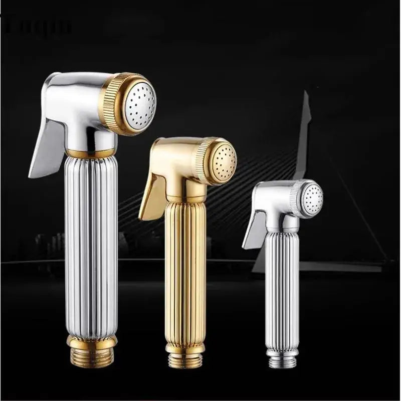 Three elegant handheld bidet sprayers in gold and silver metallic finishes for bathroom use in an elegant kit