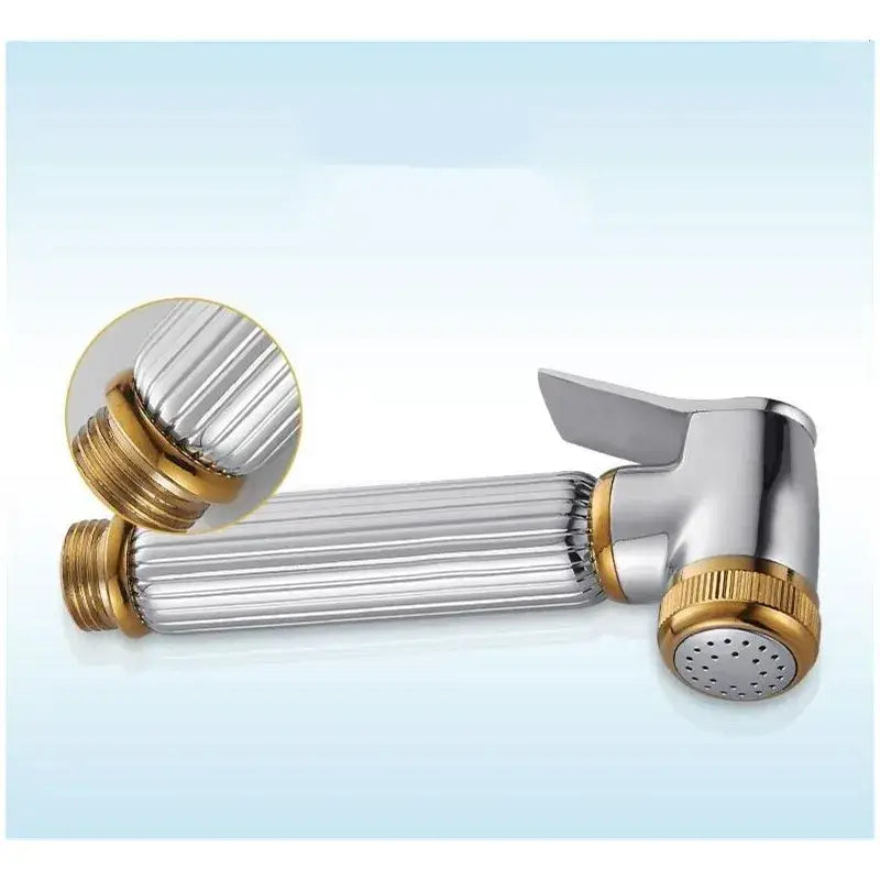 Silver and gold-toned handheld bidet sprayer with ribbed textured body for elegant bathroom use