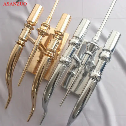 Elegant gold and silver iron claw horn wall sconce pair with ornate elongated metallic candle holders for bedroom