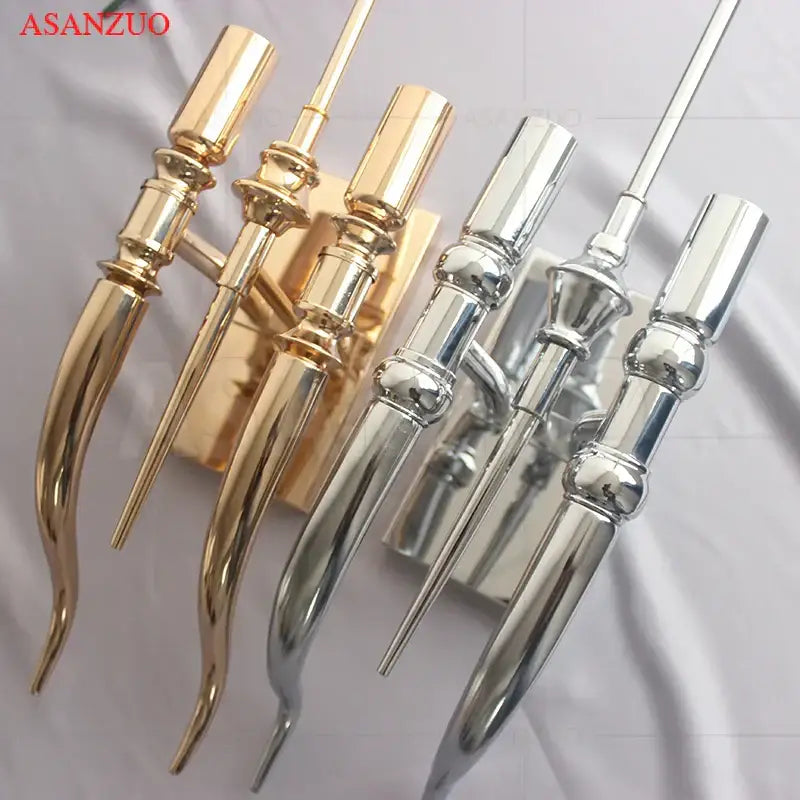 Elegant gold and silver iron claw horn wall sconce pair with ornate elongated metallic candle holders for bedroom