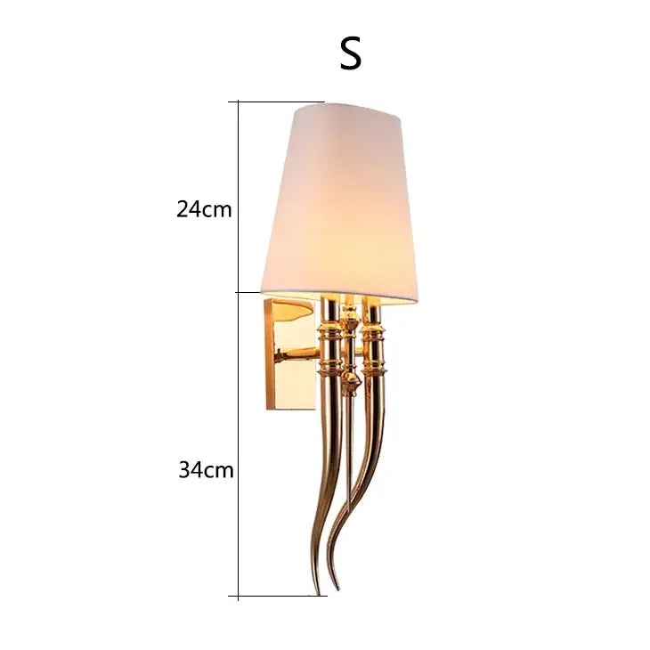 Elegant gold and silver iron claw horn wall sconce with tapered off-white shade and curved metallic arms for bedroom pair