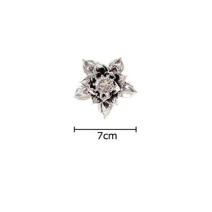 Silver lotus-shaped brooch with intricate petals and central gemstone complements elegant porcelain peony wall ornaments decorbites