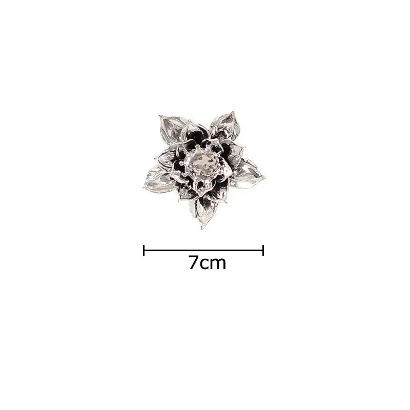 Silver lotus-shaped brooch with intricate petals and central gemstone complements elegant porcelain peony wall ornaments decorbites