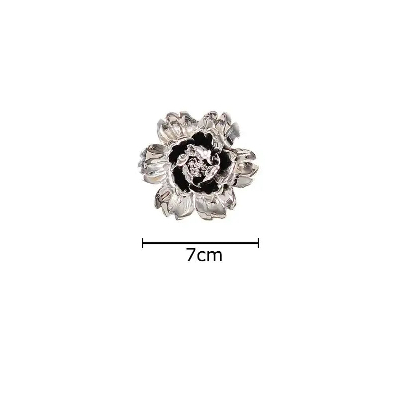 Elegant gold and silver enamel flower brooch with detailed petals complementing decorbites elegant porcelain wall ornaments