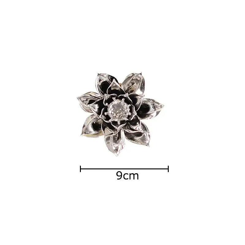 Silver lotus-shaped brooch with intricate petals and sparkling center complements decorbites elegant porcelain wall ornaments