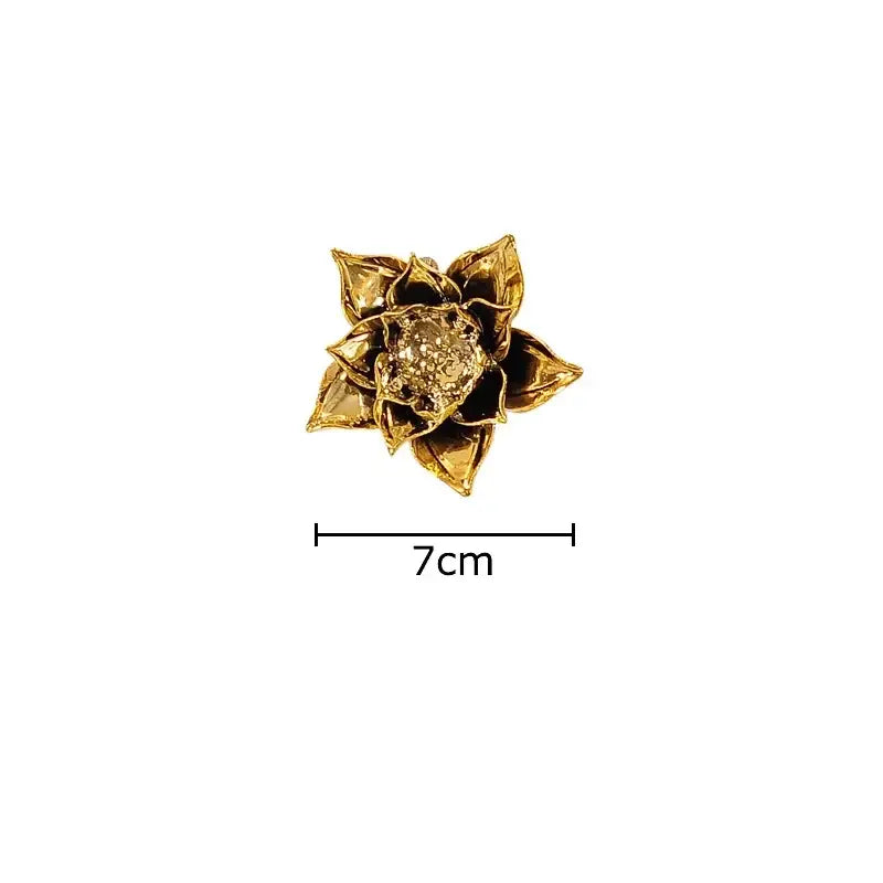 A golden lotus-shaped brooch with a textured sparkling center complements decorbites elegant porcelain peony wall ornaments